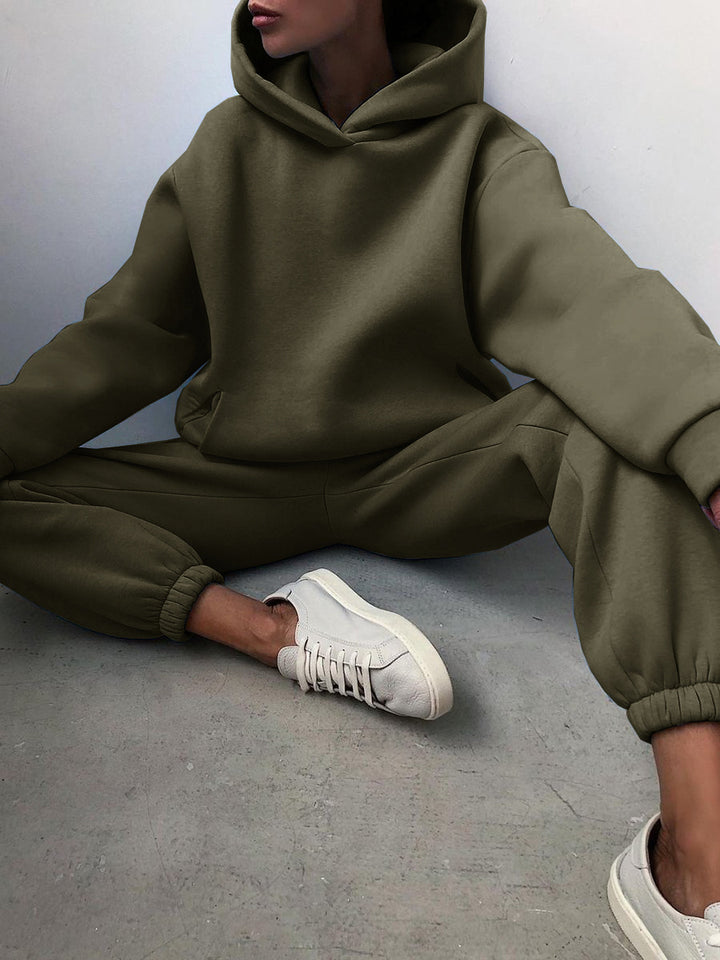 Nainen hupparissa ja collegehousuissa